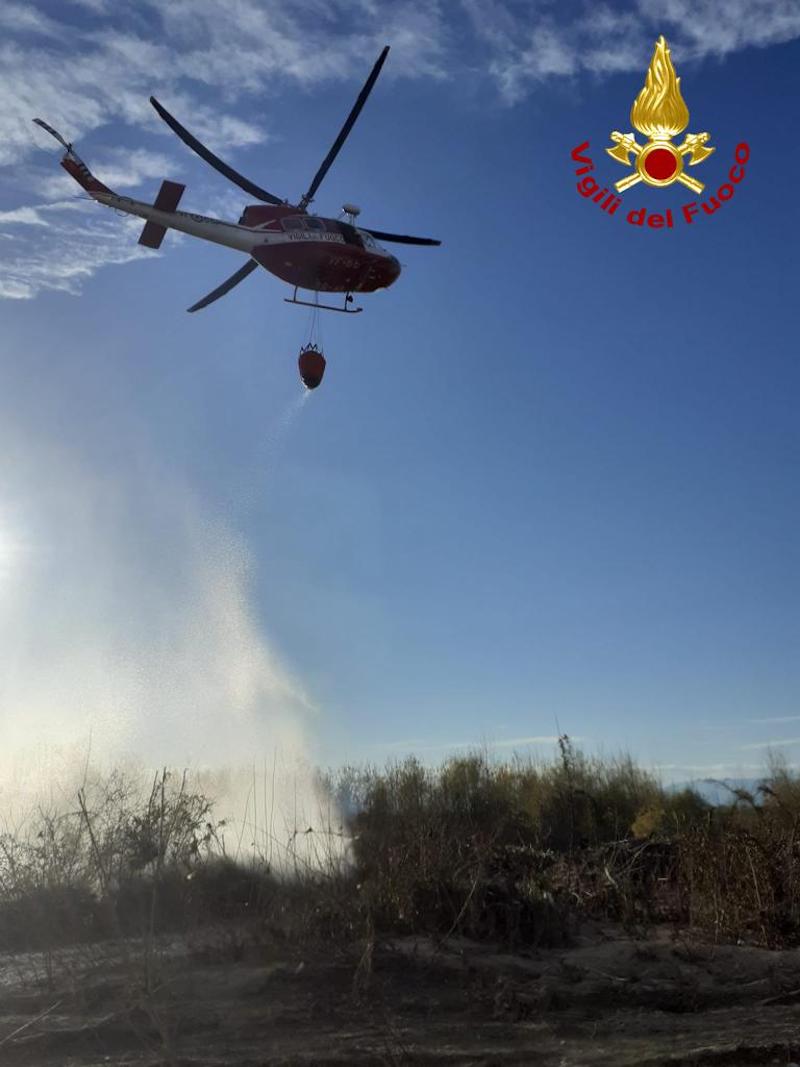 Vigili del Fuoco – Stabiuzzo (TV), Vasto incendio boschivo nel Parco del Piave, domato con lanci di acqua dall’elicottero